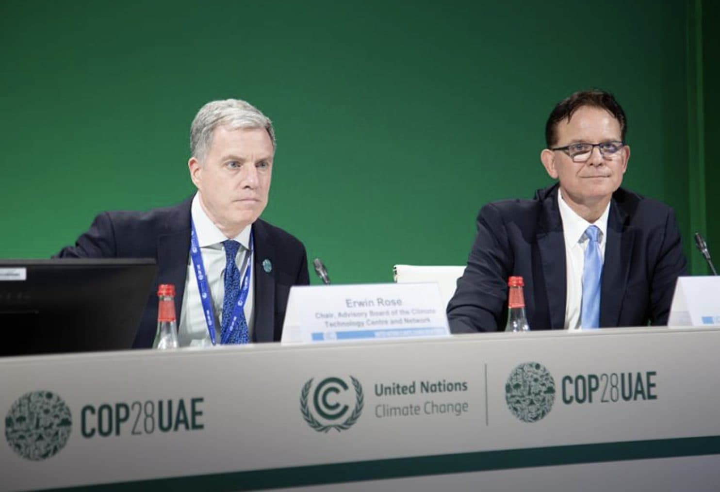 Two speakers seated at a COP28 UAE panel table in front of the UN Climate Change backdrop, one of them the chair of the CTCN advisory board.